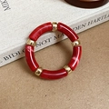 Detail of red marble-textured resin segments and gold metal beads on elastic bracelet - Round Splicing / Red
