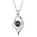 Macro shot of silver heart pendant with black center stone and micro-pave cubic zirconia - Double Layer Asymmetric Heart White Gold Color
