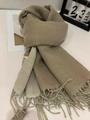 Detailed close-up of beige color-block cashmere-feel scarf with twisted tassel fringe - Khaki Beige