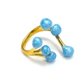 Détail d'une bague ouverte en or 18 carats avec six sphères bleues à texture marbrée - Émail Bleu Or