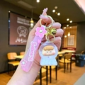 Close-up of a pink Sakura keychain with a silicone wristband and cute astronaut charm - Sakura Rope Luminous Bubble Beads Peach Figure Style / White