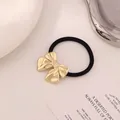 Minimalist elastic hair tie featuring a polished gold metallic bow decoration - Pleated Bow Gold