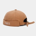 Close-up of PARIS embroidery on caramel canvas docker hat with metal eyelets - Caramel color