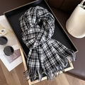 Detail of classic black and white plaid scarf with fringe on a luxury tray with accessories - 200x66cm / Black and White