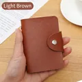 Light brown pebble leather card holder with secure metal snap button closure in hand - 24 Slots / RFID Light Brown