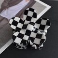 Macro detail of black and white checkerboard flower hair claw clip with acetate finish - Black/White Plaid Flower