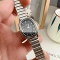 Elegant women's watch with oval black dial and silver alloy strap on a cozy desk setting - Silver Band Black Dial