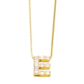 Close-up of golden letter E necklace pendant with sparkling cubic zirconia stones - Gold E