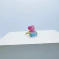 Golden heart ring with pink-blue gradient and star accents on a white display pedestal - Ring / Purple Blue