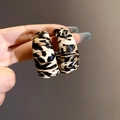 Detail shot of leopard print acrylic C-shaped earrings with textured pattern and silver pins - 8# Silver Earring Post - Coffee Round