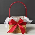 Detail view of woven seagrass gift basket with large red bow and gold star mesh lining - Burgundy Half Wrap Style