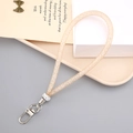 Detail van een gouden mesh telefoonkoordje met strasstenen en een zilveren karabijnhaak - Maas Touw Hanger(K3678) / Champagne