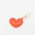 Detail of orange heart-shaped PU leather keychain with gold hardware and fine stitching - With Buckle / Orange