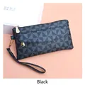 Detail of checkered PU leather handbag with gold zipper and a wristlet strap - Black