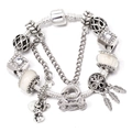 Detail of silver charm bracelet with white beads and heart key pendants on white background - Bear Feather Theme (L09)