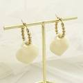 Golden beaded hoop earrings featuring a white acrylic heart pendant on T-stand - White