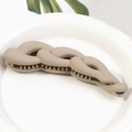 Matte beige twist banana hair clip with chain design on white ceramic plate - Milk Coffee