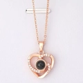 Detail of rose gold double heart pendant featuring a black projection stone and zircon inlay - Multi-Diamond Heart Rose Gold
