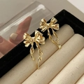Elegant gold bow-shaped ribbon stud earrings displayed in a premium jewelry gift box - Gold Bowknot Ribbon
