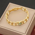 Macro detail of a gold hollow link bracelet featuring a round light green cat eye gemstone - Gold Hollow Oval Inlaid Light Green Gemstone Style (2#)