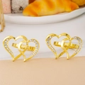 Close-up of luxury gold heart napkin rings with crystal diamonds for table decor - Gold Rhinestone Double Heart