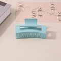 Matte light blue rectangular claw clip for thick hair shown in a lifestyle setting - #7 Frosted Lake Blue - 8.5cm / Bulk (No Packaging)
