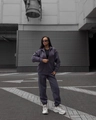 Detail of purple zip-up hoodie and high-waist joggers set on model in urban street setting - Slate Gray