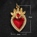 Detail view of a 27x15mm gold heart pendant with red stone and sparkling zirconia trim - Leaf Heart Red Gem Style (A0039)
