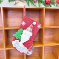 Red linen Christmas stocking featuring Santa Claus and tree hanging on a wooden rack - Linen Fence Medium Stocking (Santa Style)