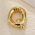 Macro detail of a 18K gold plated bubble letter Q pendant with polished finish - Letter Q
