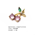 Macro detail of a 14x18mm gold cherry pendant with pink zircon and green leaf - Size 6