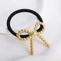 Elastic black hair tie featuring a golden beaded metallic bow charm accessory - Gold Beaded Butterfly Knot