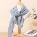 Detail of light blue pleated square scarf draped on a mannequin for a stylish spring look - Grey Blue
