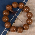Macro detail of old-material sandalwood beads with natural grain on a blue book - Plain Style / 20mm*12 Beads