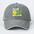 Close-up of Just One More Game embroidery and yellow pickleball on gray washed denim cap - Gray