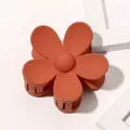 Macro detail of a matte brick red flower hair claw clip with a secure grip structure - Matte Flower Hair Clip - Dark Orange
