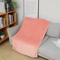 Soft pink coral fleece blanket neatly draped over a sofa for home comfort - Plain Coral Pink