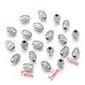 Macro detail of 7mm silver stainless steel spacer beads with 2mm hole for DIY jewelry - Oval Beads-Steel Color / 5x7x2mm