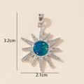 Detailed view of silver starburst pendant with teal glitter inlay and white cubic zirconia - Silver Sun Star