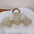 Detailed view of elegant golden heart-shaped hair claw clip with faux pearls and rhinestones - Triple Heart Pearl Claw Clip