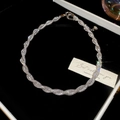 Detail view of twisted silver necklace with zircon in a premium jewelry gift box - Entwined / Silver / Necklace