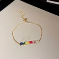 Adjustable gold bracelet featuring a vibrant row of rectangular rainbow zircon stones - Gold Rainbow