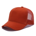 Detail of burnt orange trucker hat featuring breathable mesh back and curved brim - Brick Red