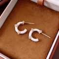 Detail of rose gold C-shaped earrings with pink enamel and sparkling crystals in a box - Silver Earring Post - Gold - Pink