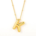Polished golden stainless steel bubble letter K pendant on a fine beaded necklace chain - Gold - K