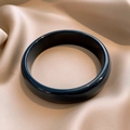 Detailed view of dark resin bangle with polished finish on elegant silk fabric - 36# Bangle-Blue-Round