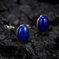 Macro shot of gold-plated oval deep blue jade cufflinks on a dark textured rock background - Natural Lapis Lazuli Oval Gold 5*7mm