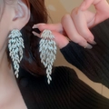 Macro shot of silver crystal feather earrings with dangling tassels on model - Layered Feather Rhinestone Tassel Style (6#银针-银色)