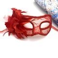 Detailed view of red lace party mask featuring large fabric flowers and elegant feathers - One Size / Red