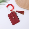Detail of red leather card holder with silicone bead wristlet and elegant tassel - Red